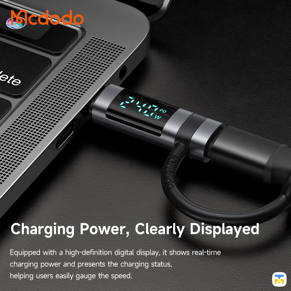 Laptop with a charging cable displaying real-time charging power on a dark surface, featuring the Mcdodo brand.